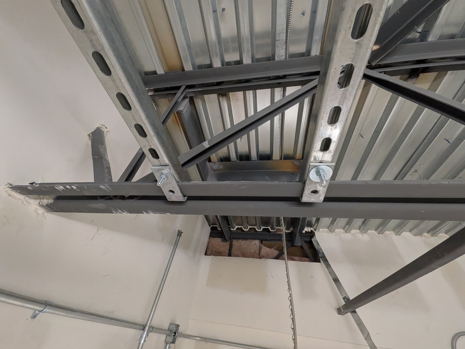 Strut channel frame supporting equipment from the roof structure